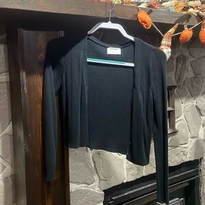 Black, cover up jacket. Goes well over a dress.